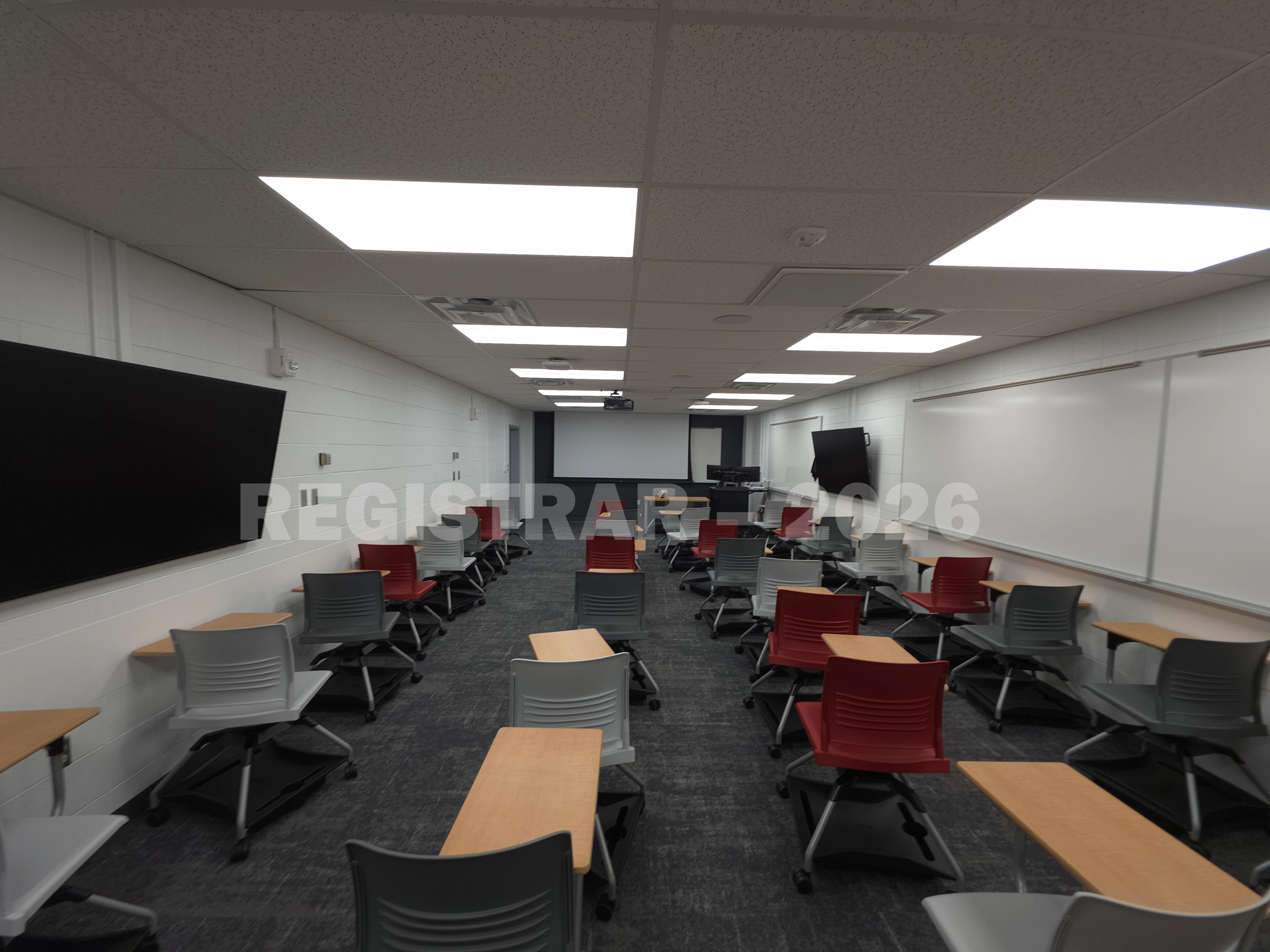 University Hall room 66 ultra wide angle view from the back of the room with projector screen down