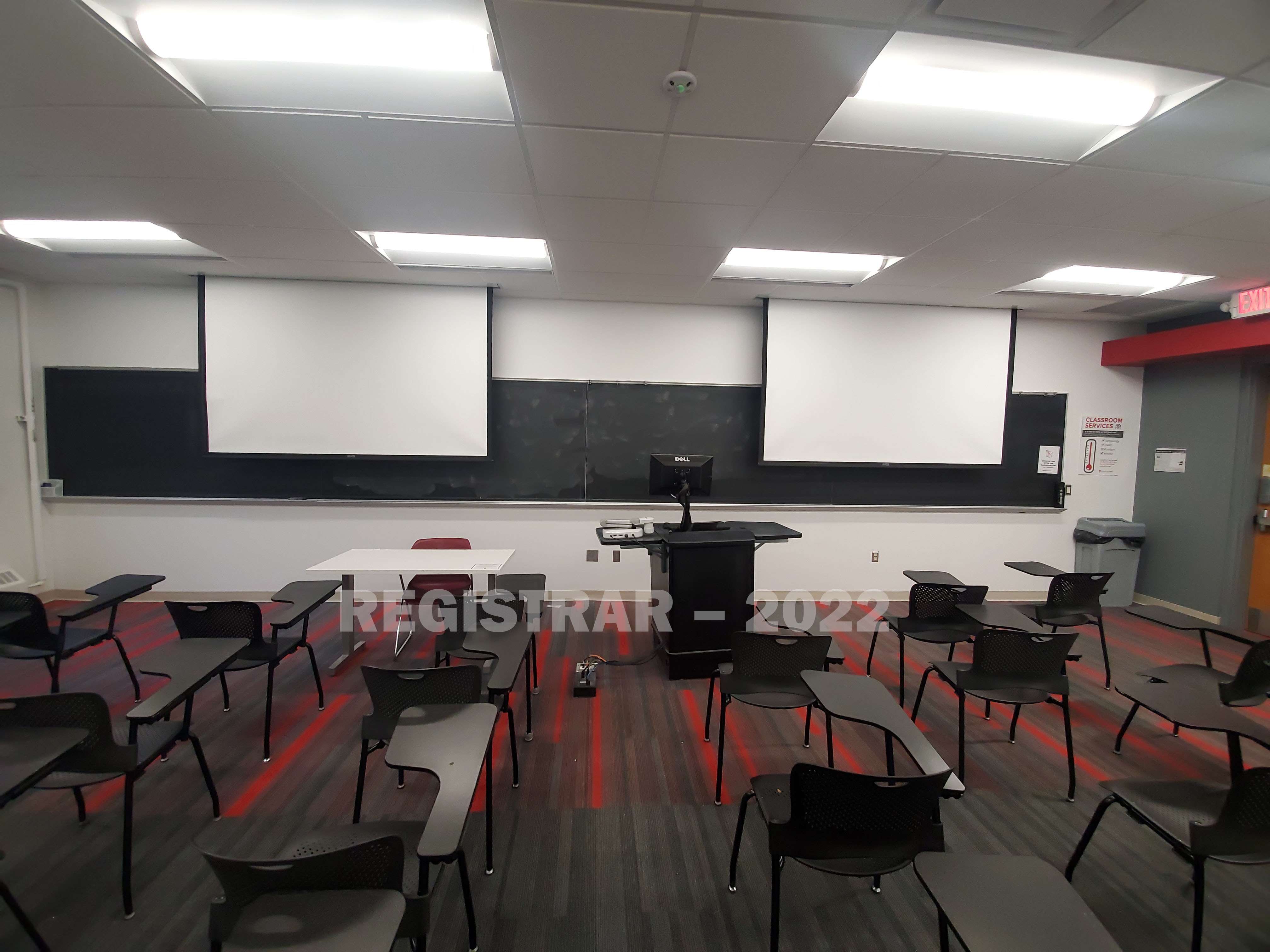 Baker Systems Engineering room 136 ultra wide angle view from the back of the room with projector screen down