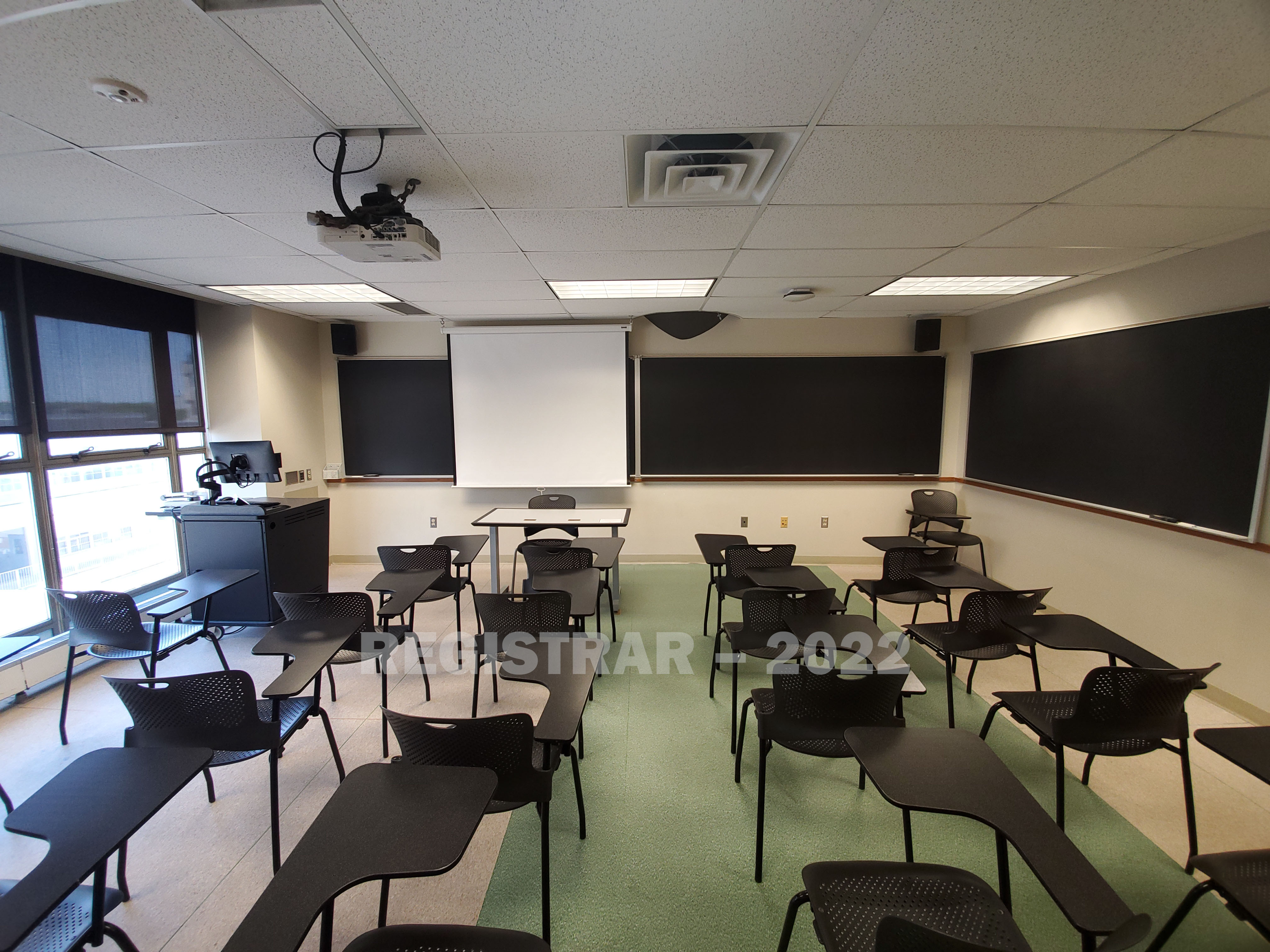 Enarson Classroom Building room 346 ultra wide angle view from the back of the room with projector screen down