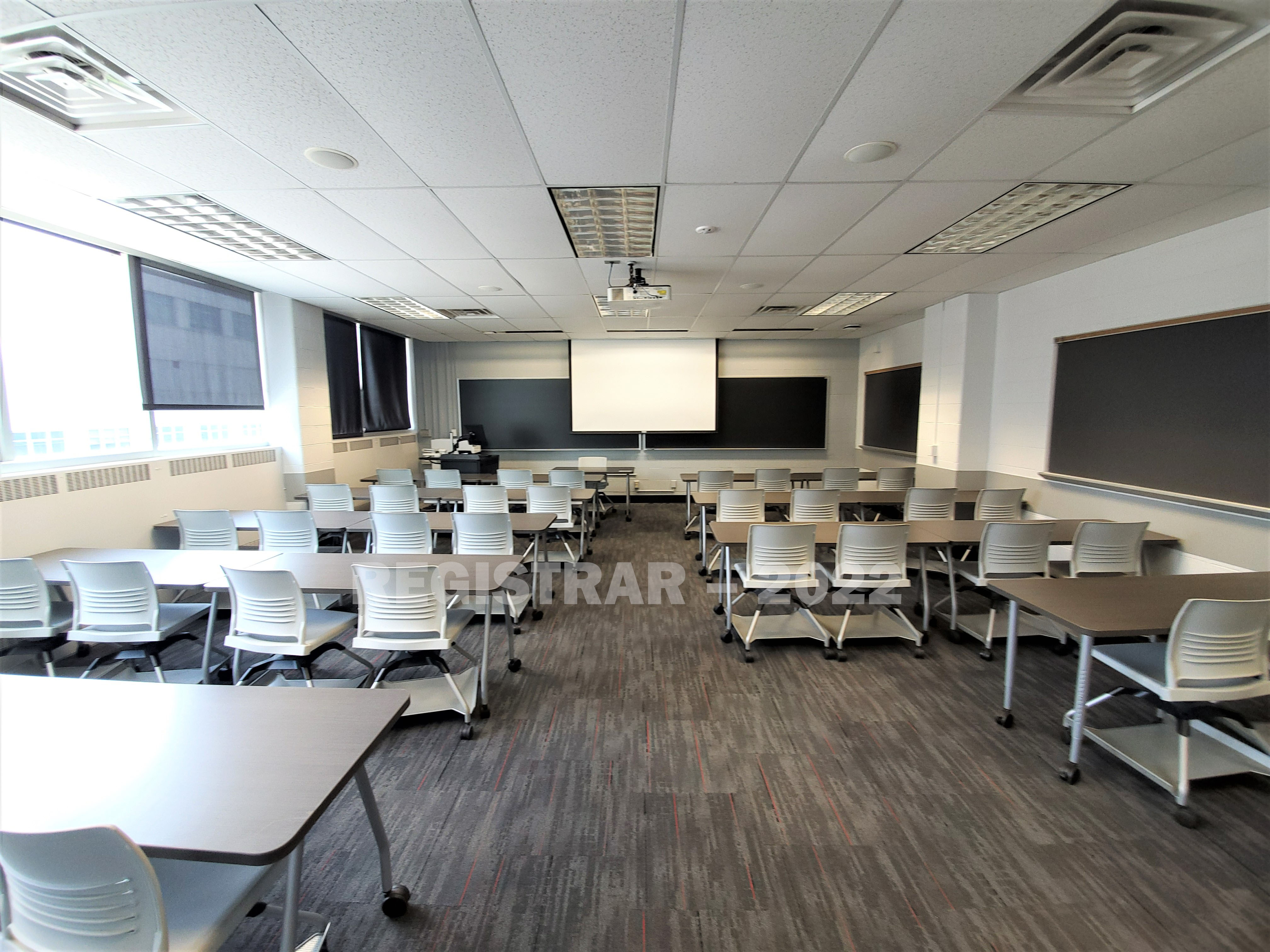 Bolz Hall room 316 ultra wide angle view from the back of the room with projector screen down