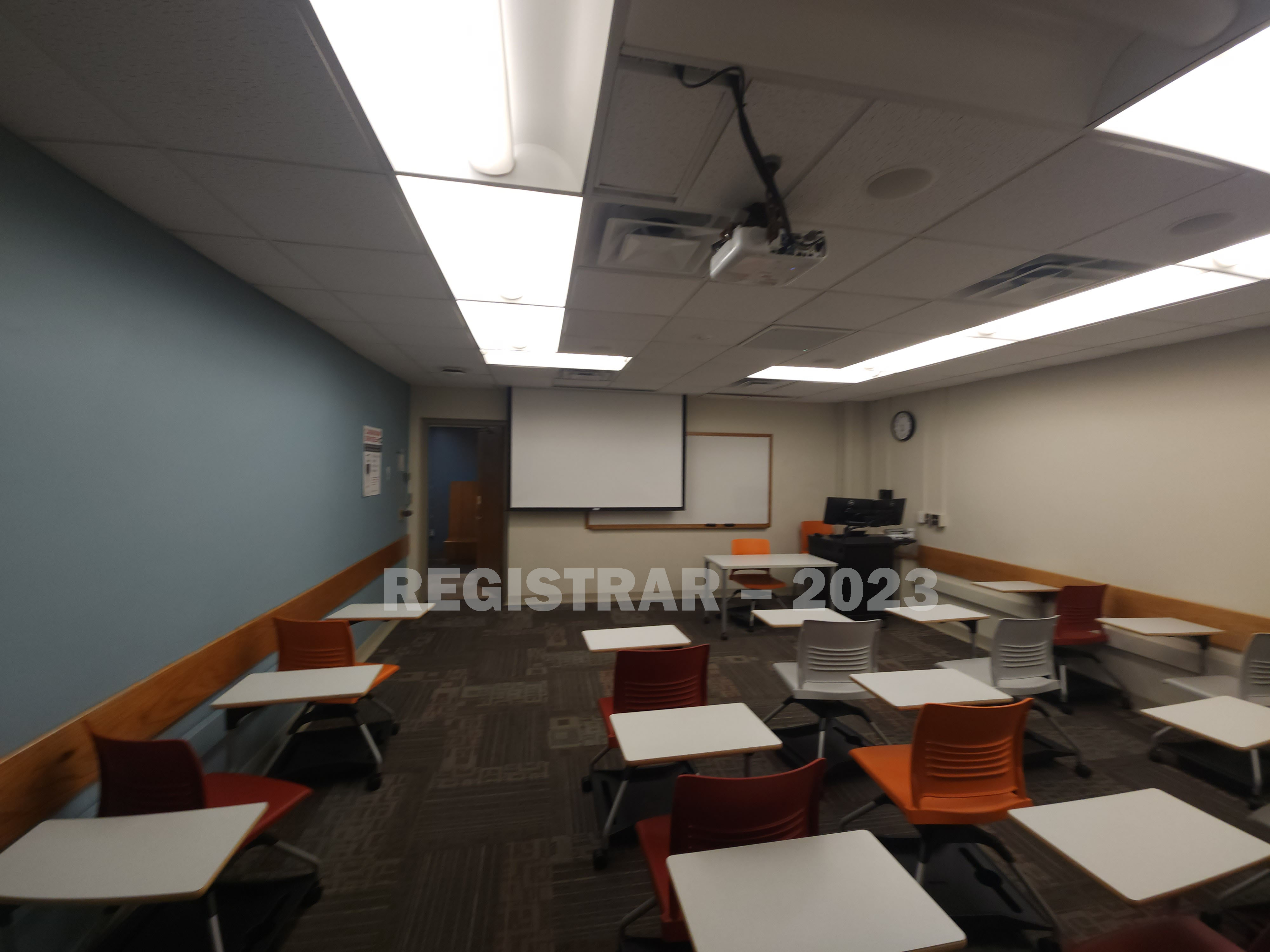 Journalism Building room 291 ultra wide angle view from the back of the room with projector screen down