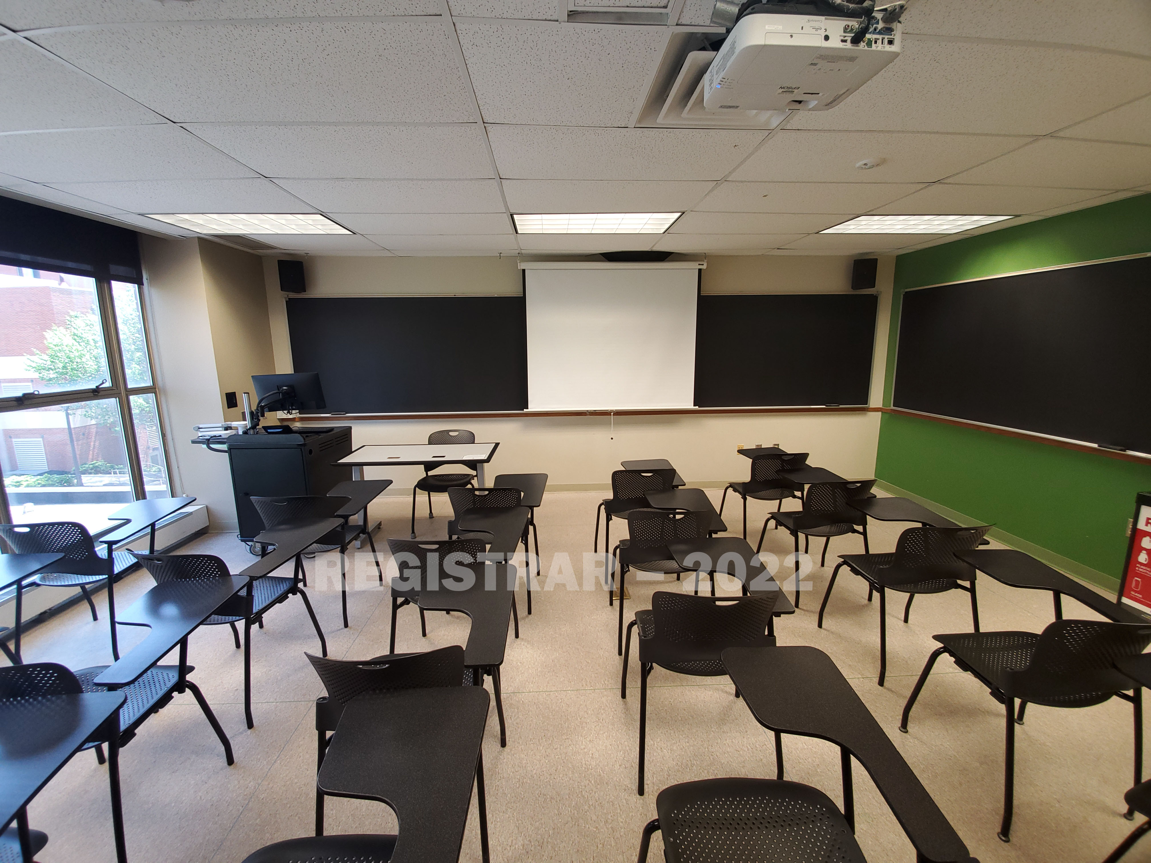 Enarson Classroom Building room 312 ultra wide angle view from the back of the room with projector screen down