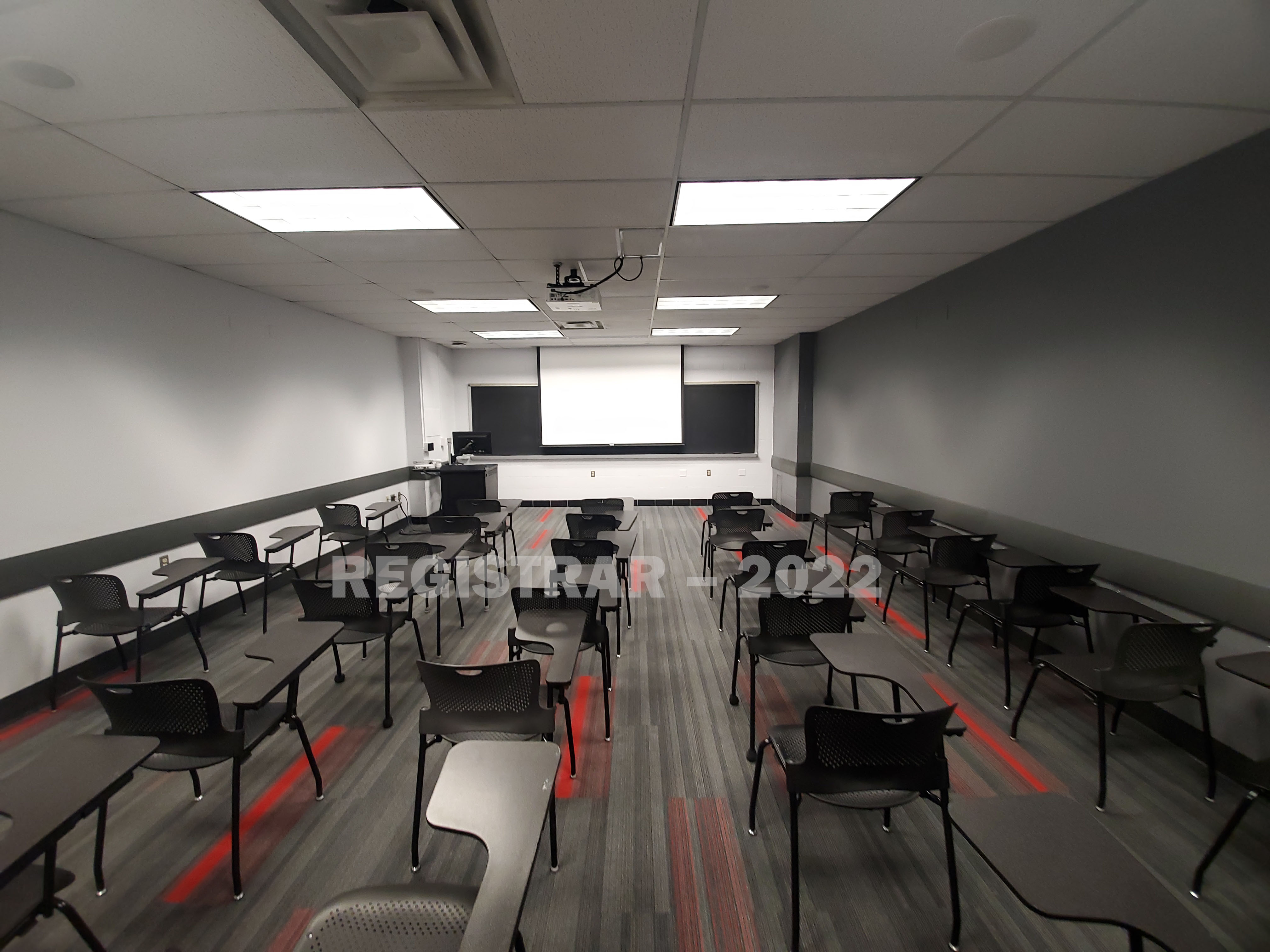 Baker Systems Engineering room 184 ultra wide angle view from the back of the room with projector screen down
