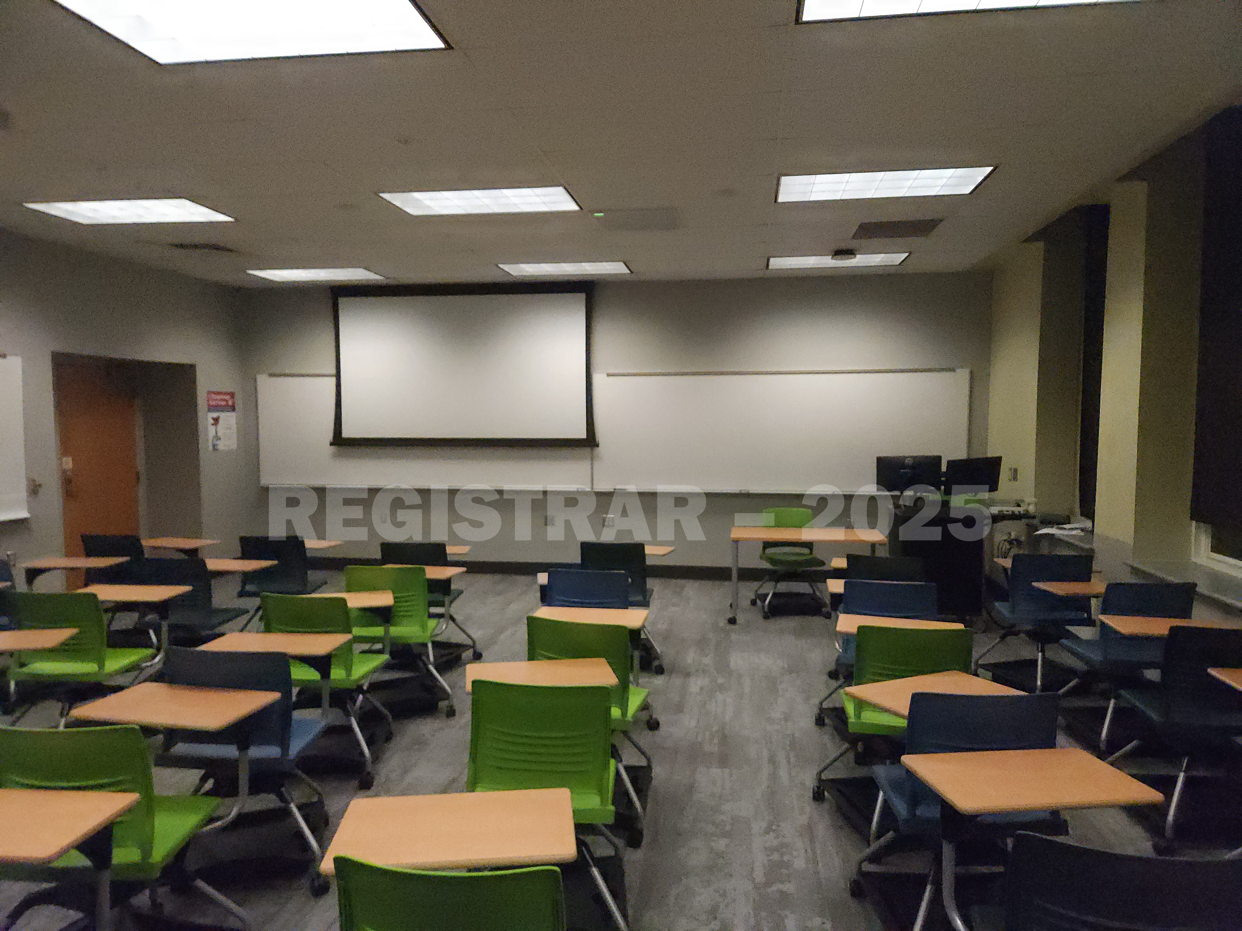 Mendenhall Laboratory room 185  view from the back of the room with projector screen down