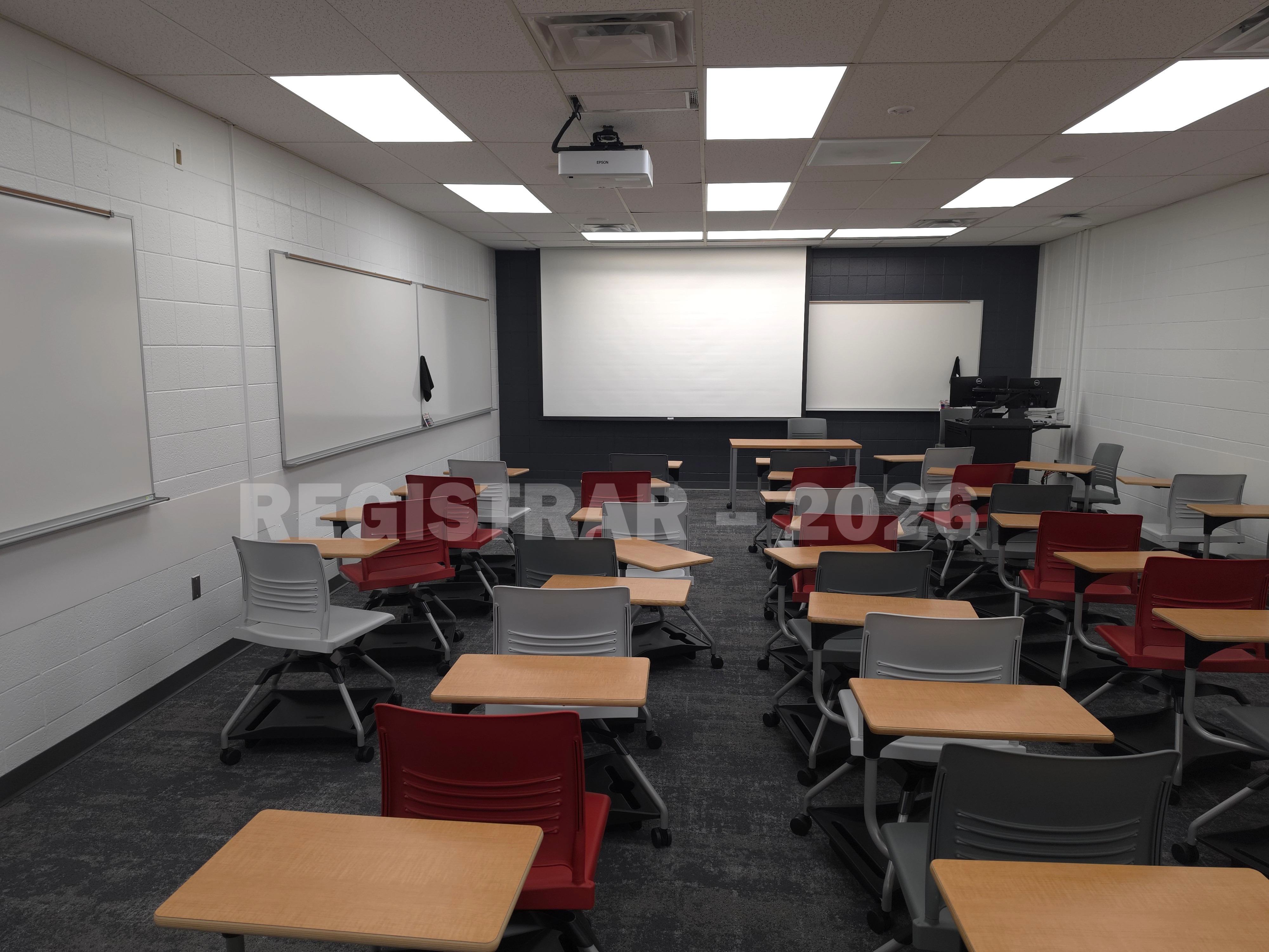 University Hall room 82 view from the back of the room with projector screen down