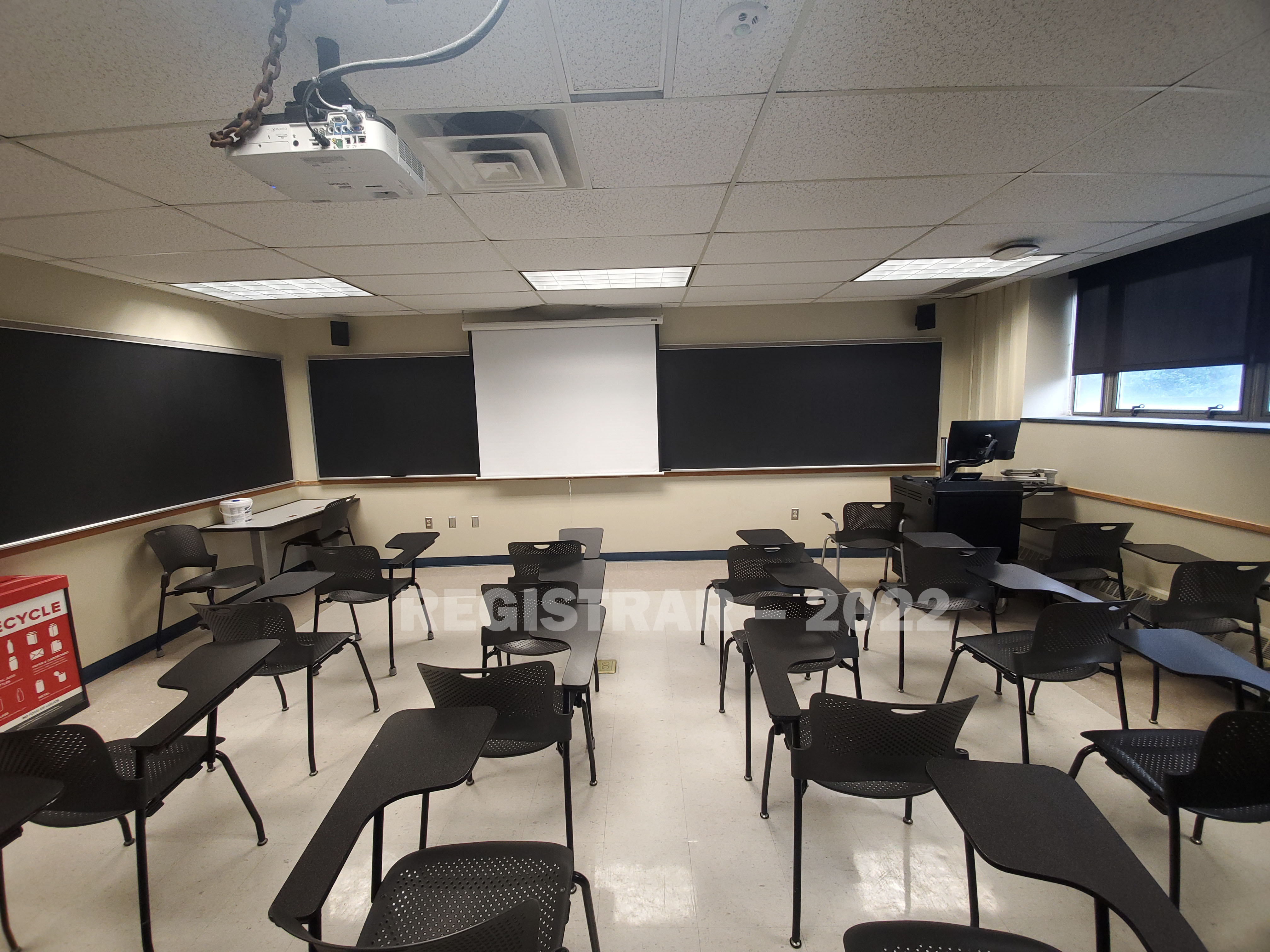 Enarson Classroom Building room 206 ultra wide angle view from the back of the room with projector screen down