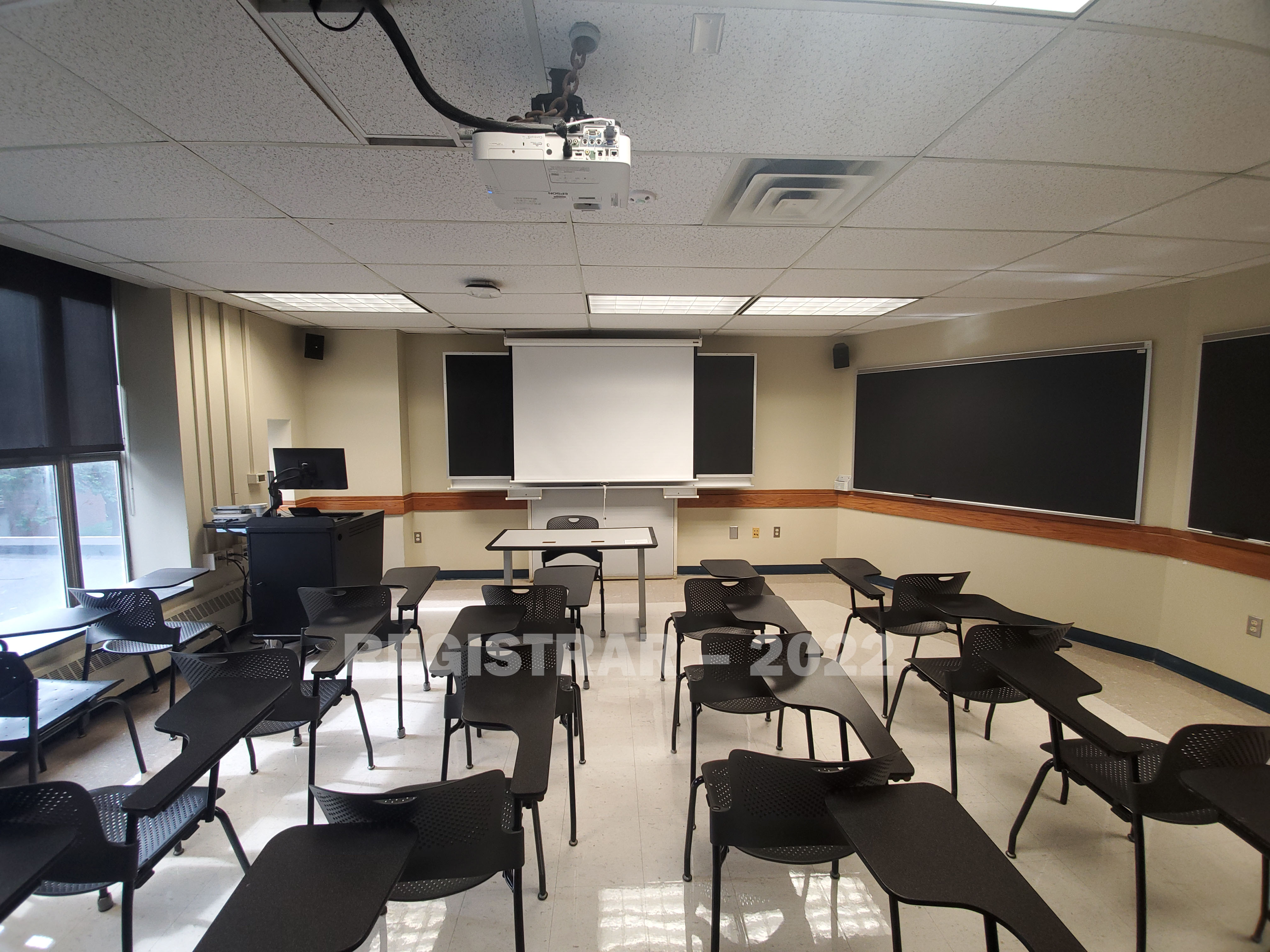 Enarson Classroom Building room 202 ultra wide angle view from the back of the room with projector screen down
