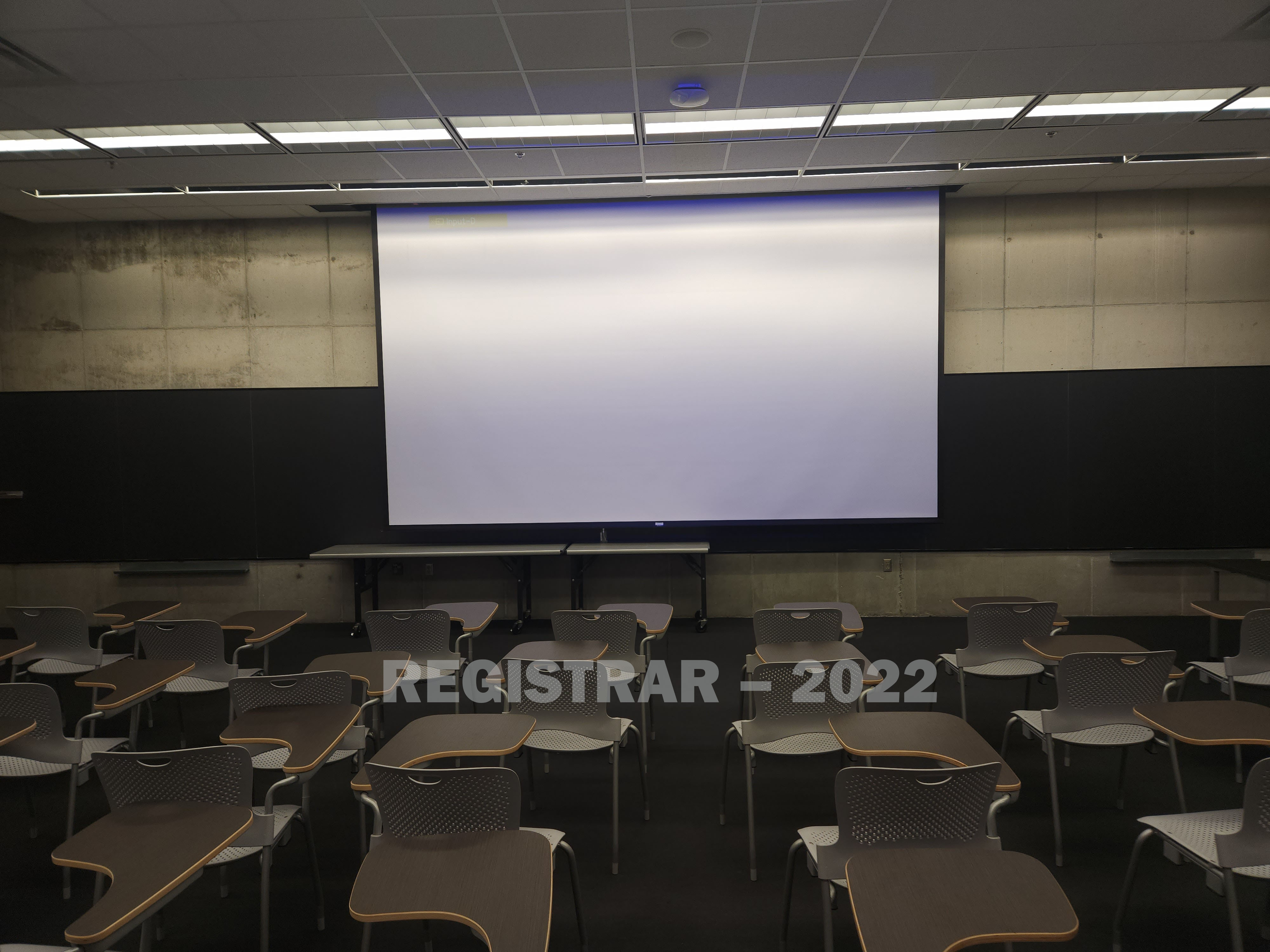 Knowlton Hall room 190 view from the back of the room with projector screen down