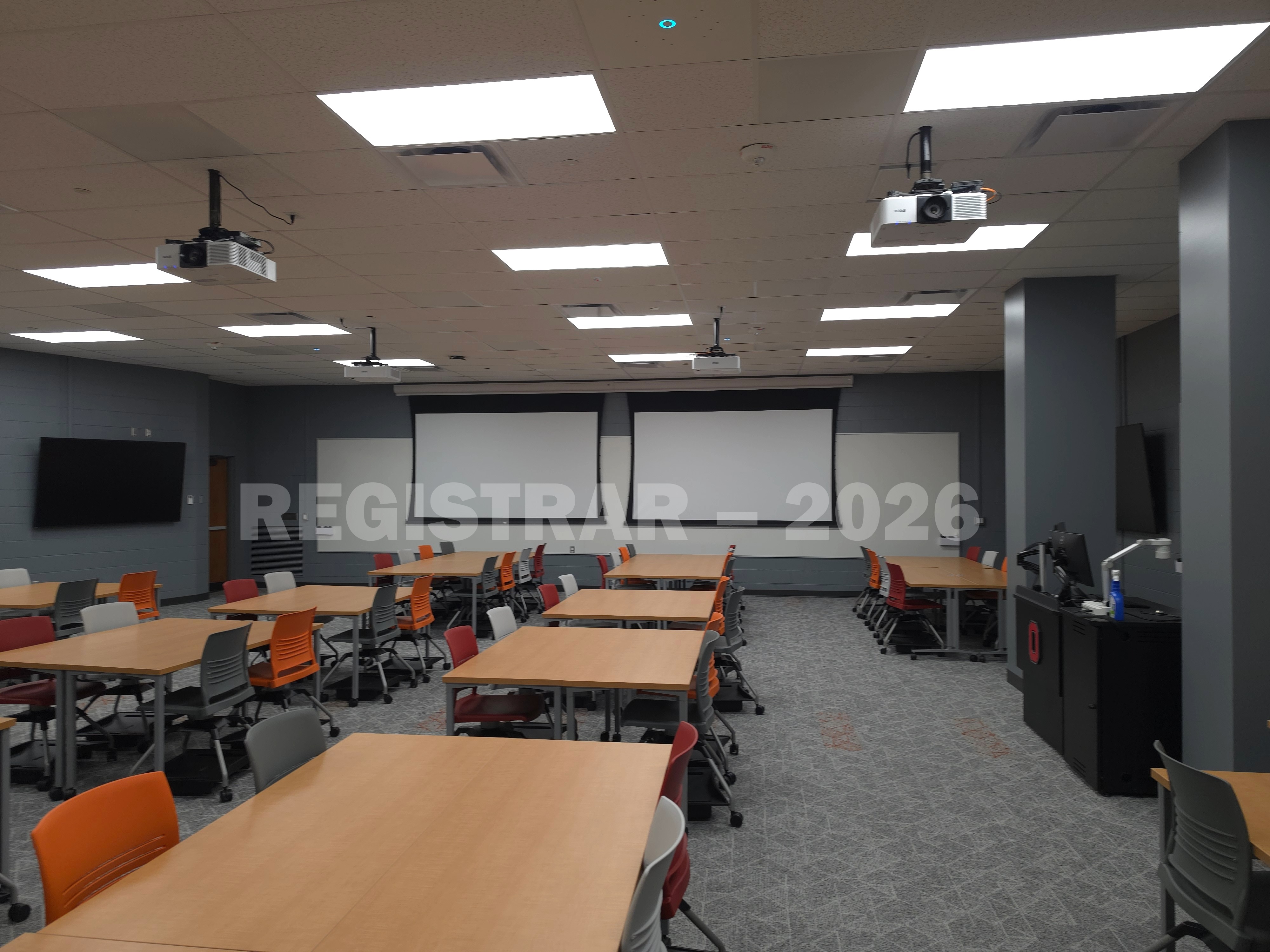 Agricultural Engineering Building room 100 angle view from the left side of the room with the projector screens down