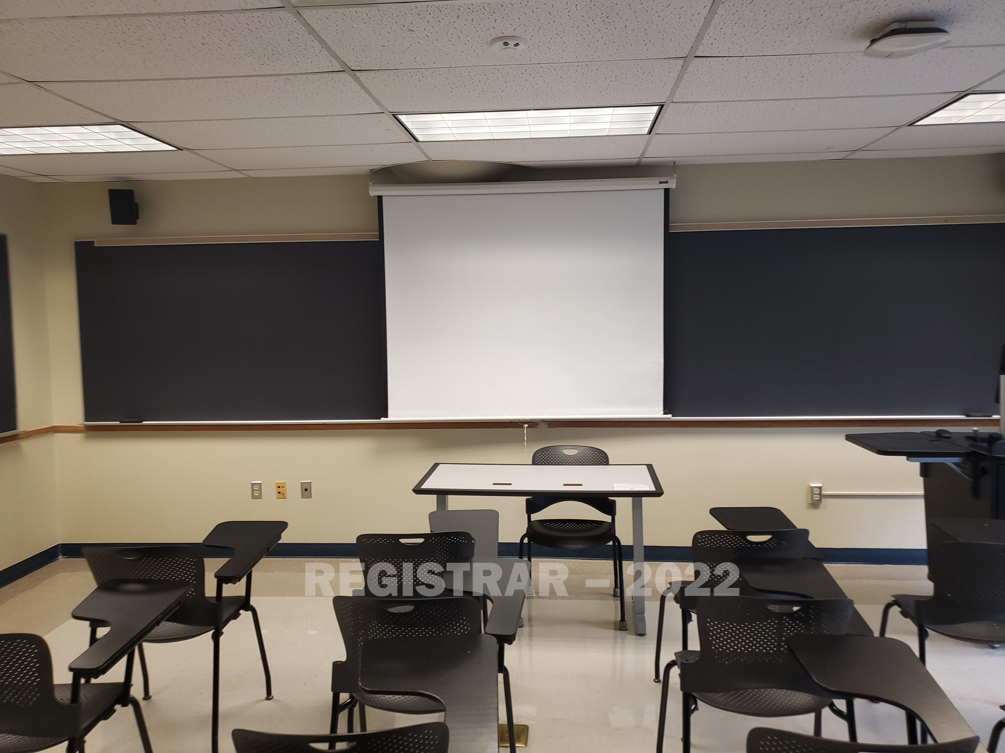 Enarson Classroom Building room 314 view from the back of the room with projector screen down