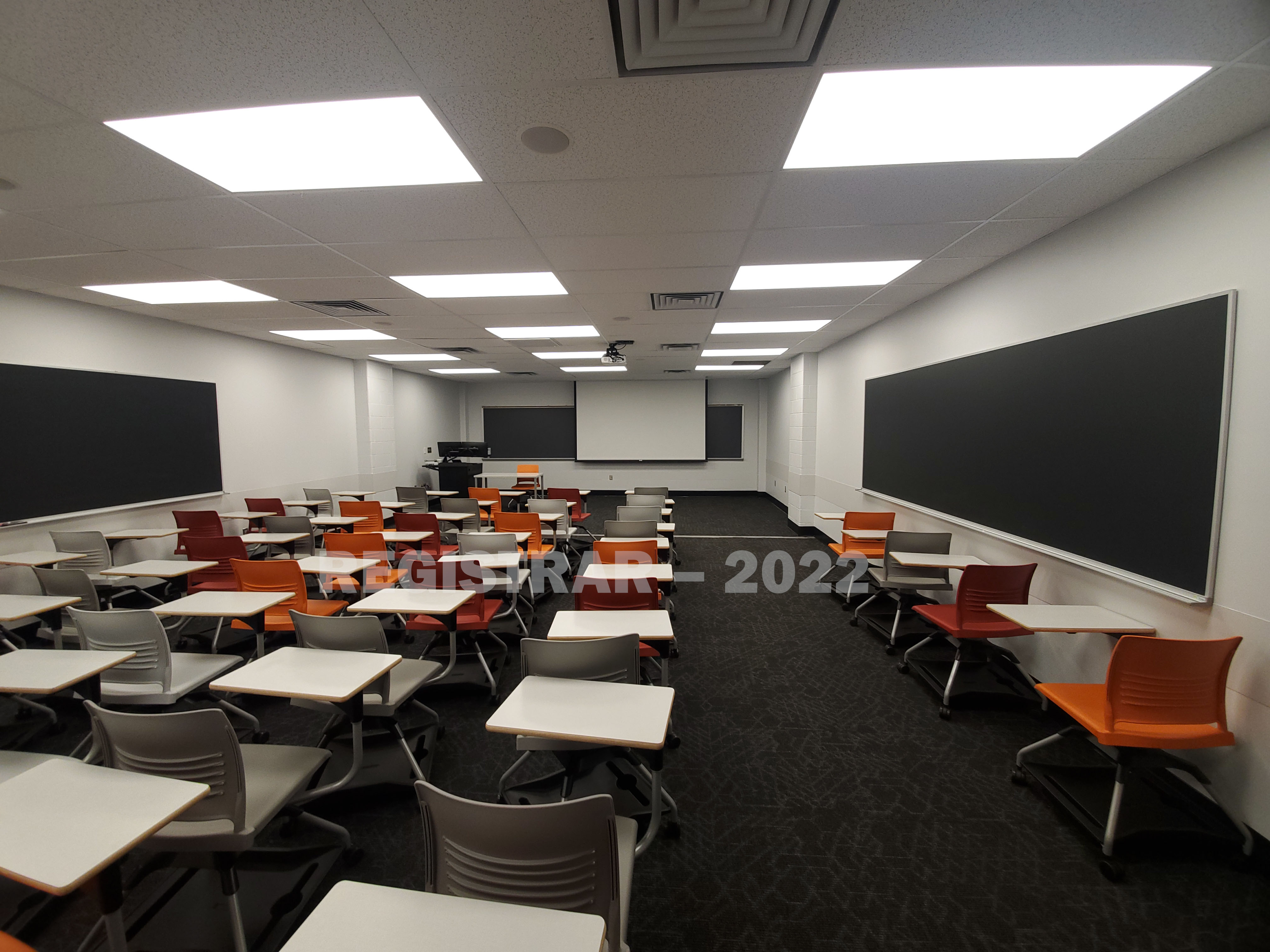Journalism Building room 371 ultra wide angle view from the back of the room with projector screen down