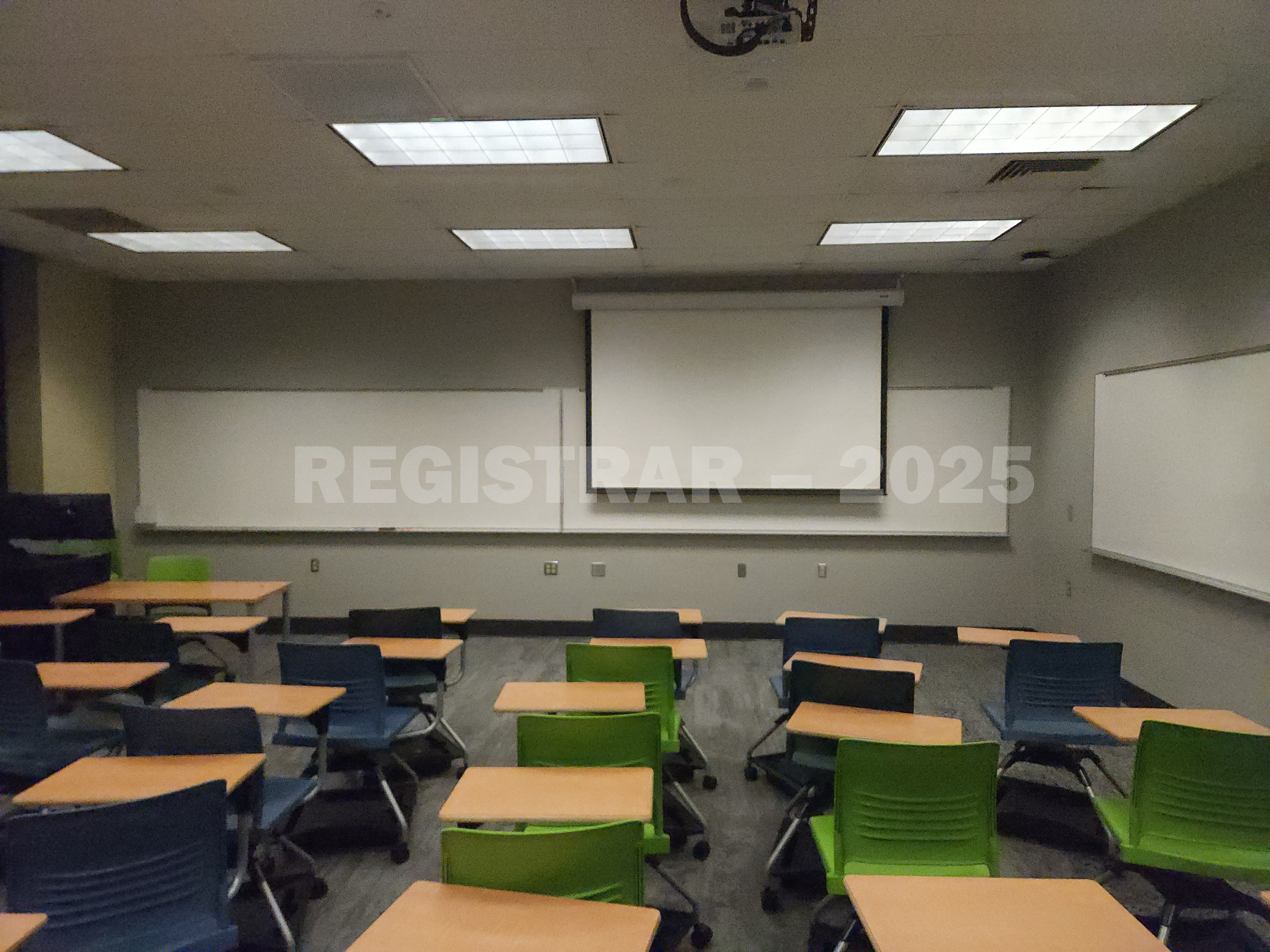 Mendenhall Laboratory room 175  view from the back of the room with projector screen down