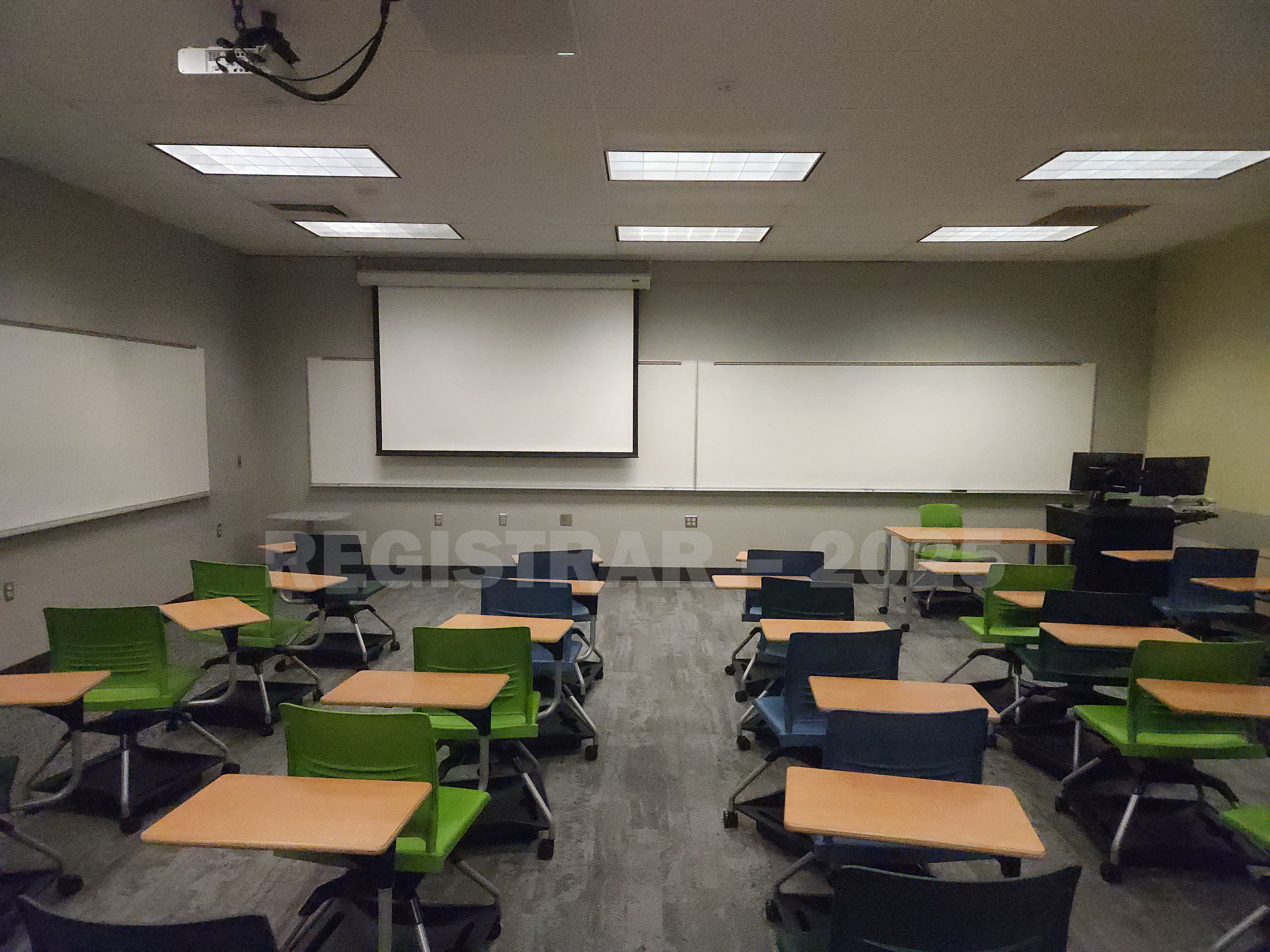 Mendenhall Laboratory room 173  view from the back of the room with projector screen down