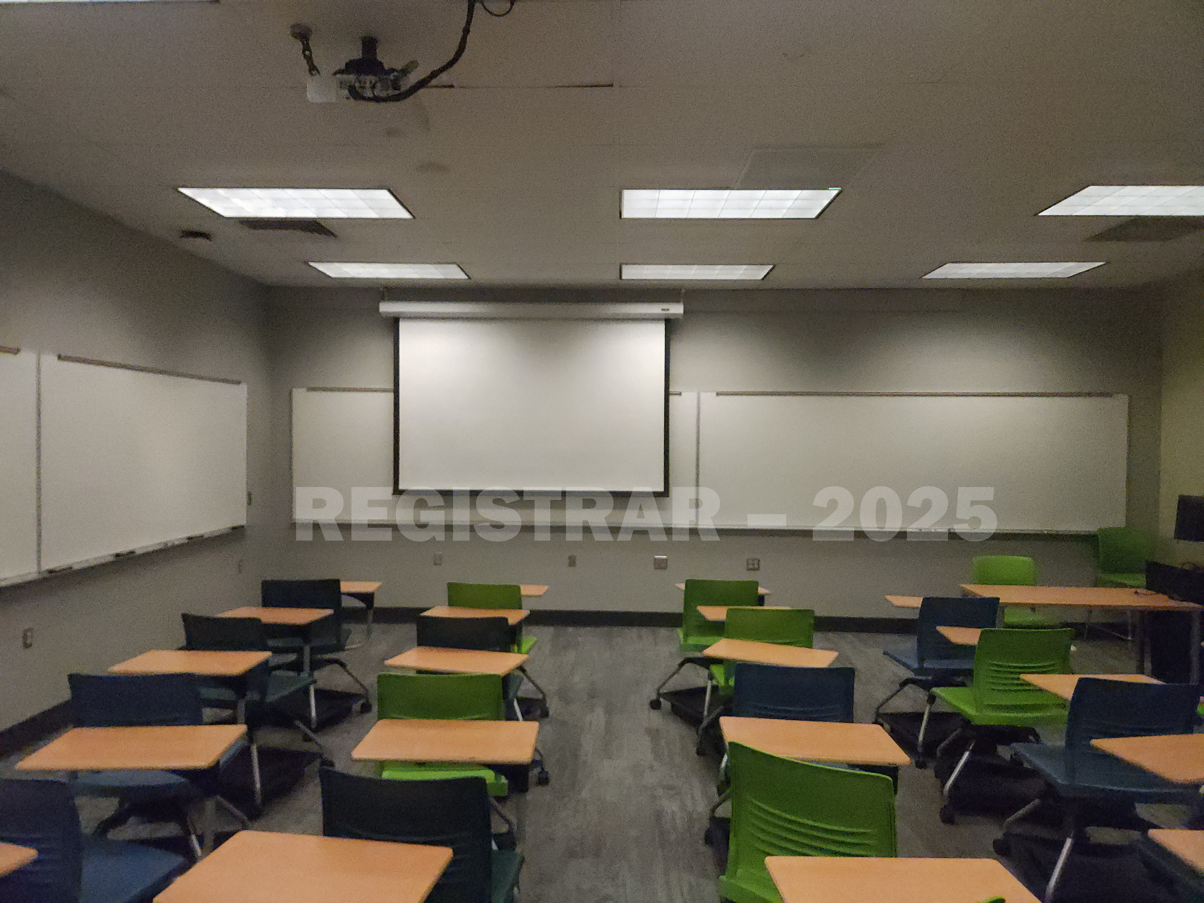 Mendenhall Laboratory room 129  view from the back of the room with projector screen down