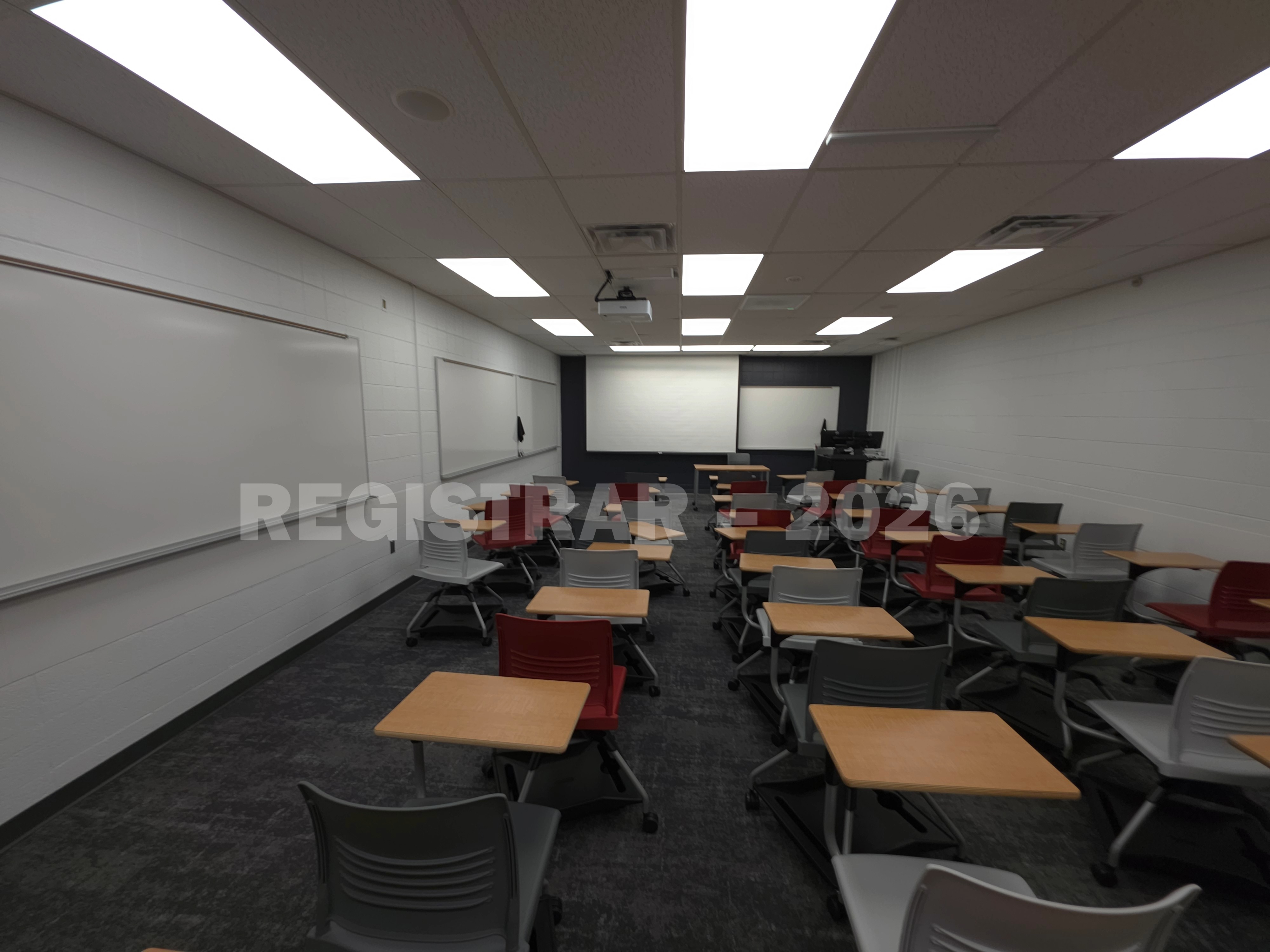 University Hall room 82 ultra wide angle view from the back of the room with projector screen down