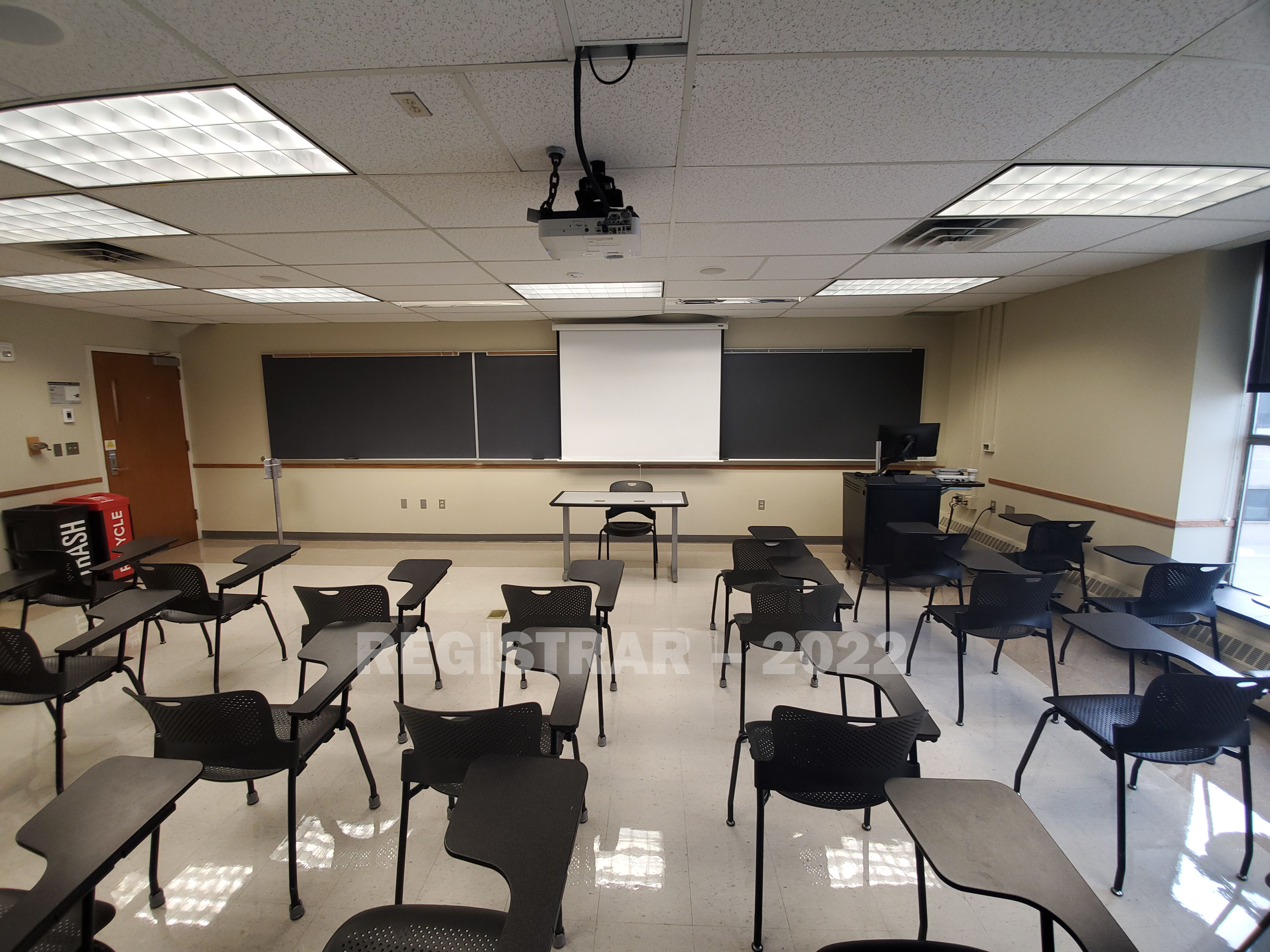 Enarson Classroom Building room 254 ultra wide angle view from the back of the room with projector screen down