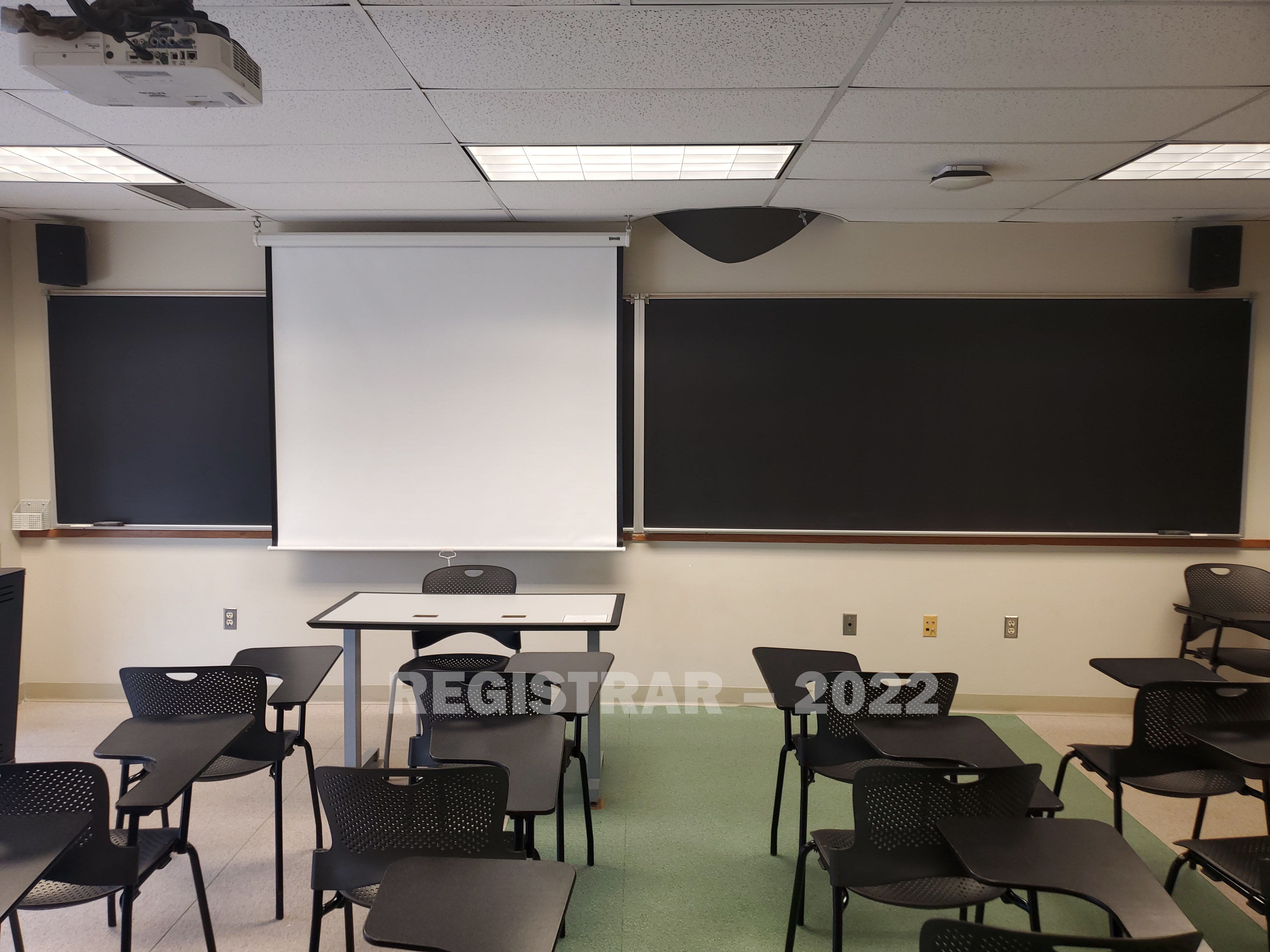 Enarson Classroom Building room 346 view from the back of the room with projector screen down