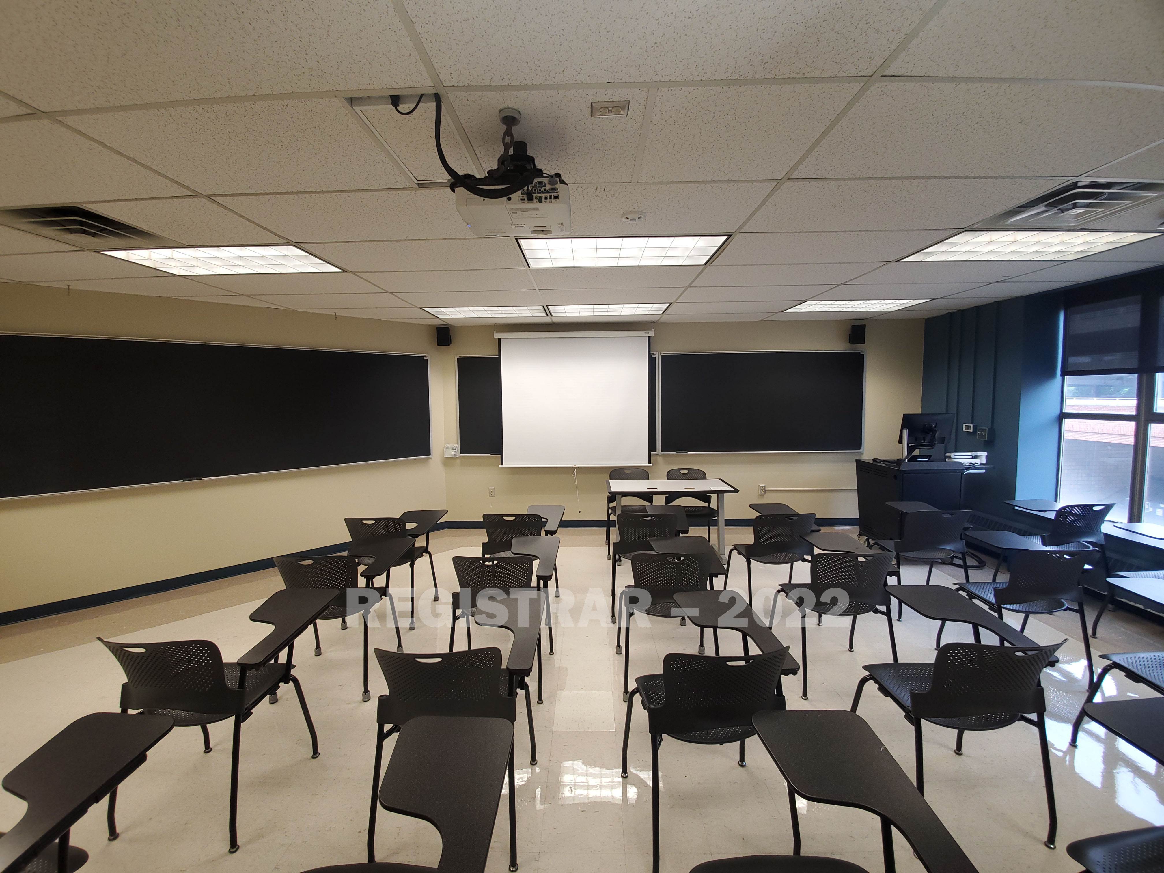 Enarson Classroom Building room 230 ultra wide angle view from the back of the room with projector screen down