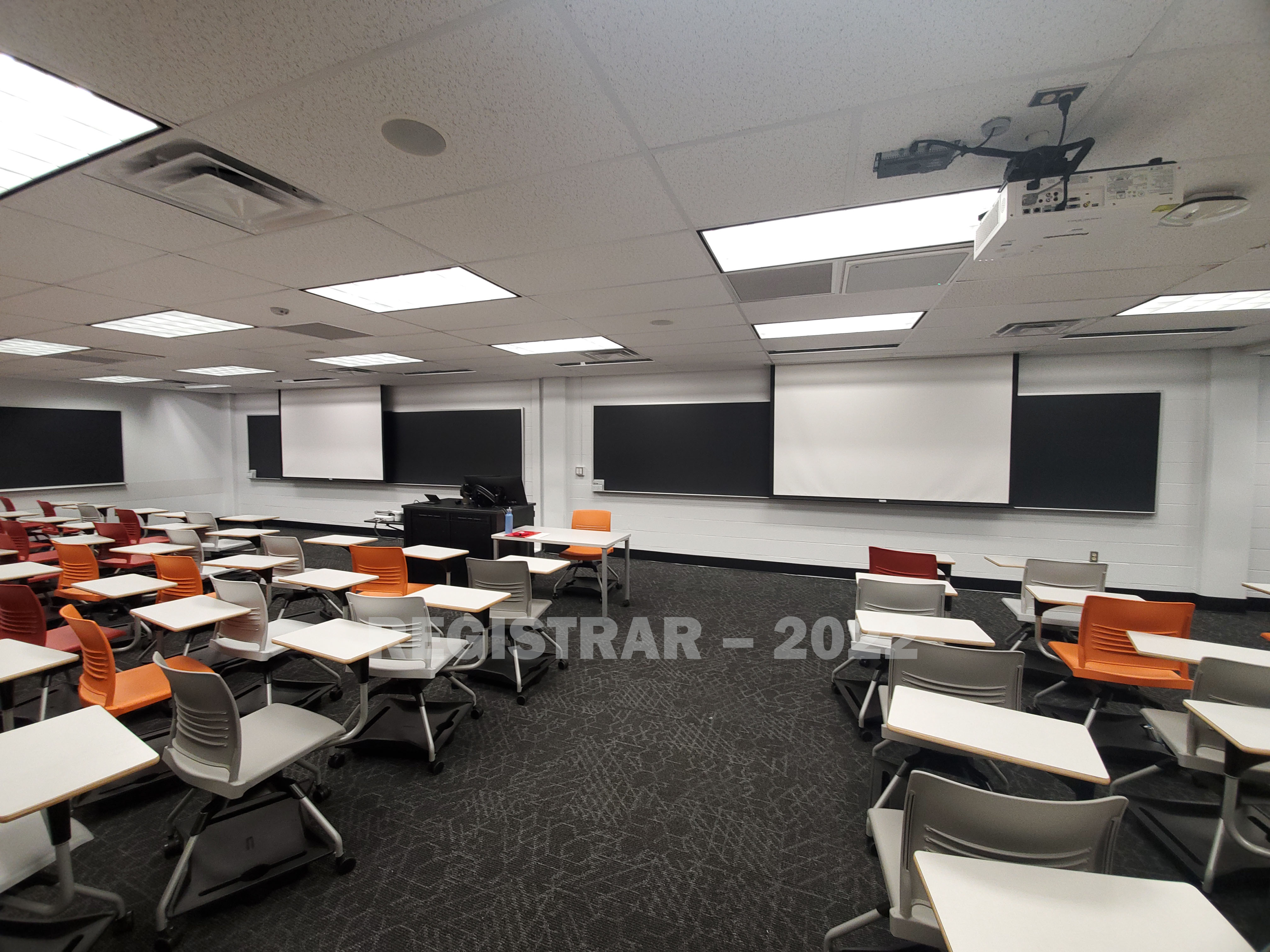 Journalism Building room 270 ultra wide angle view from the back of the room with projector screen down