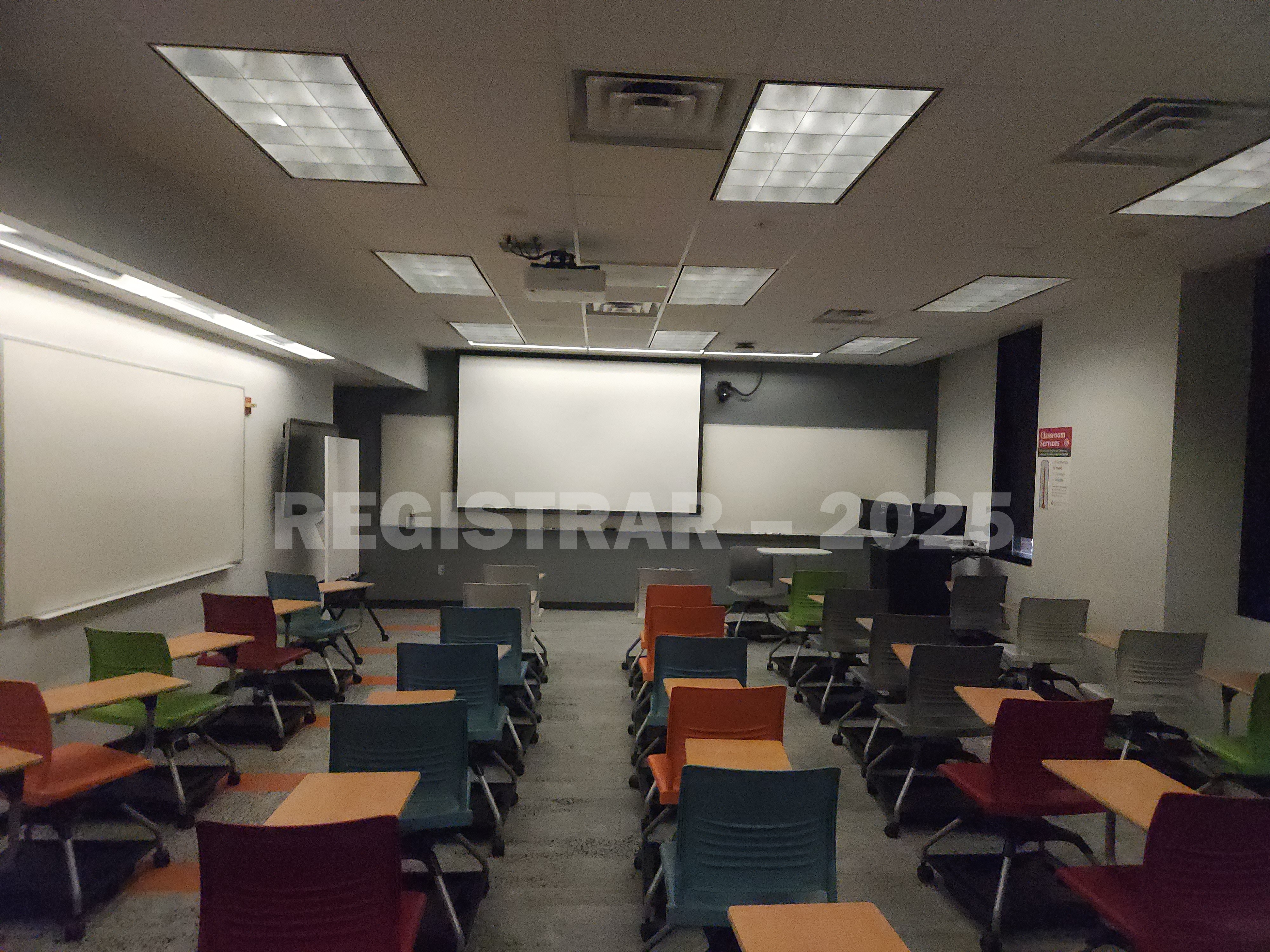 McPherson Chemical Lab room 1035 view from the back of the room with the projection screen down