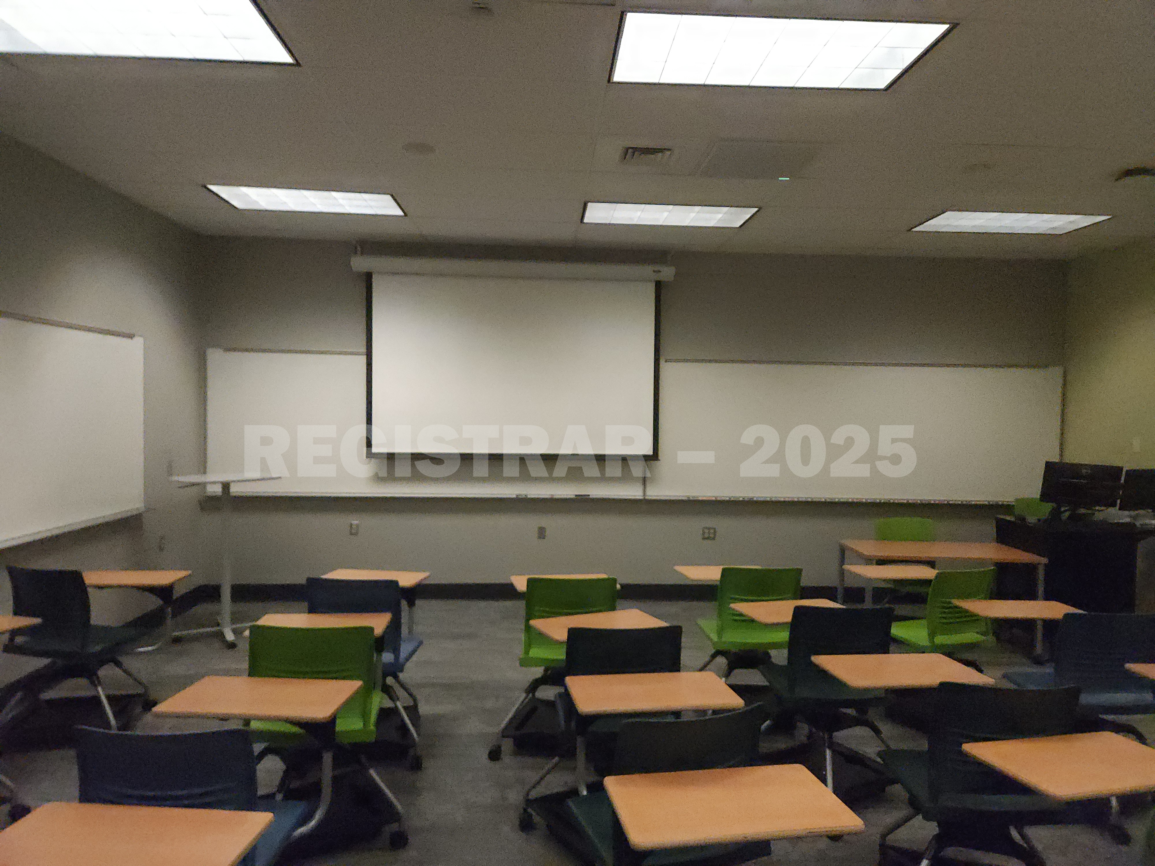 Mendenhall Laboratory room 174  view from the back of the room with projector screen down