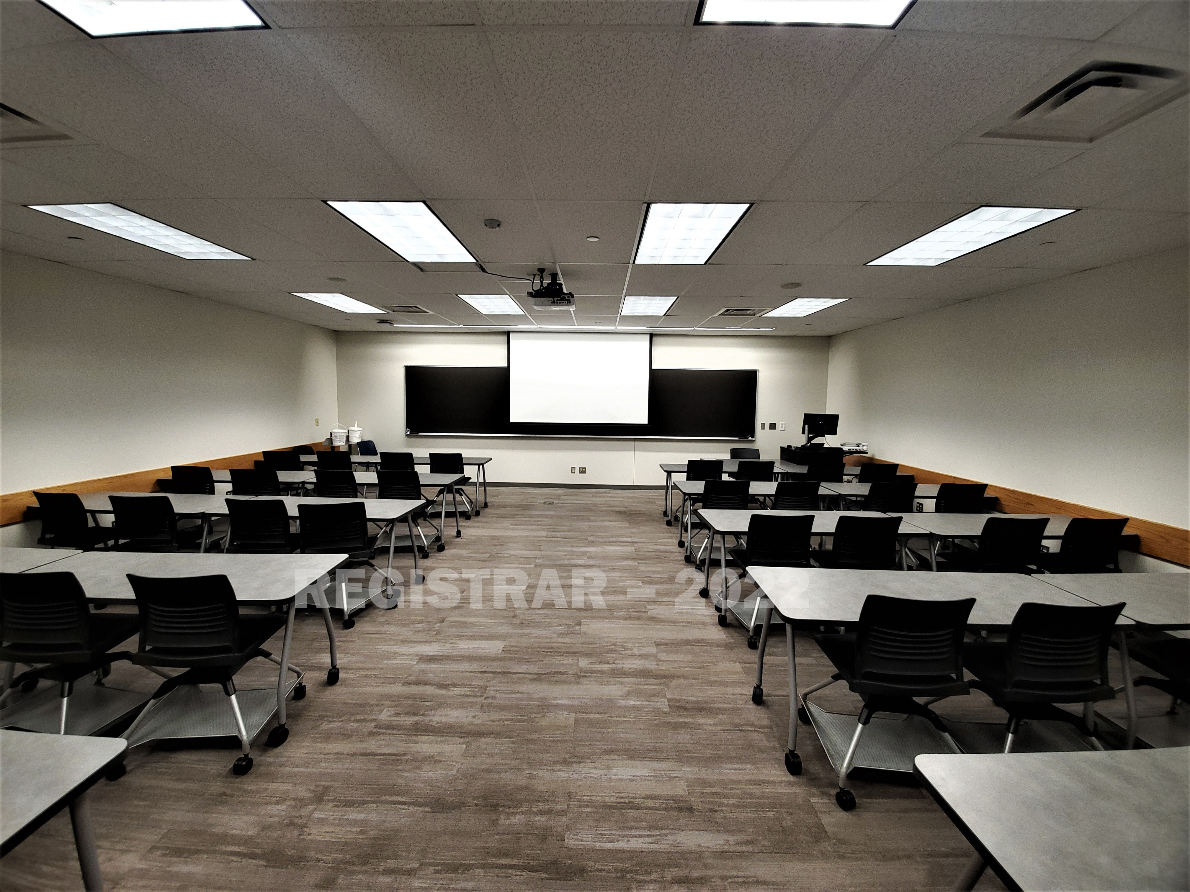 Dreese Lab room 264 ultra wide angle view from the back of the room with projector screen down
