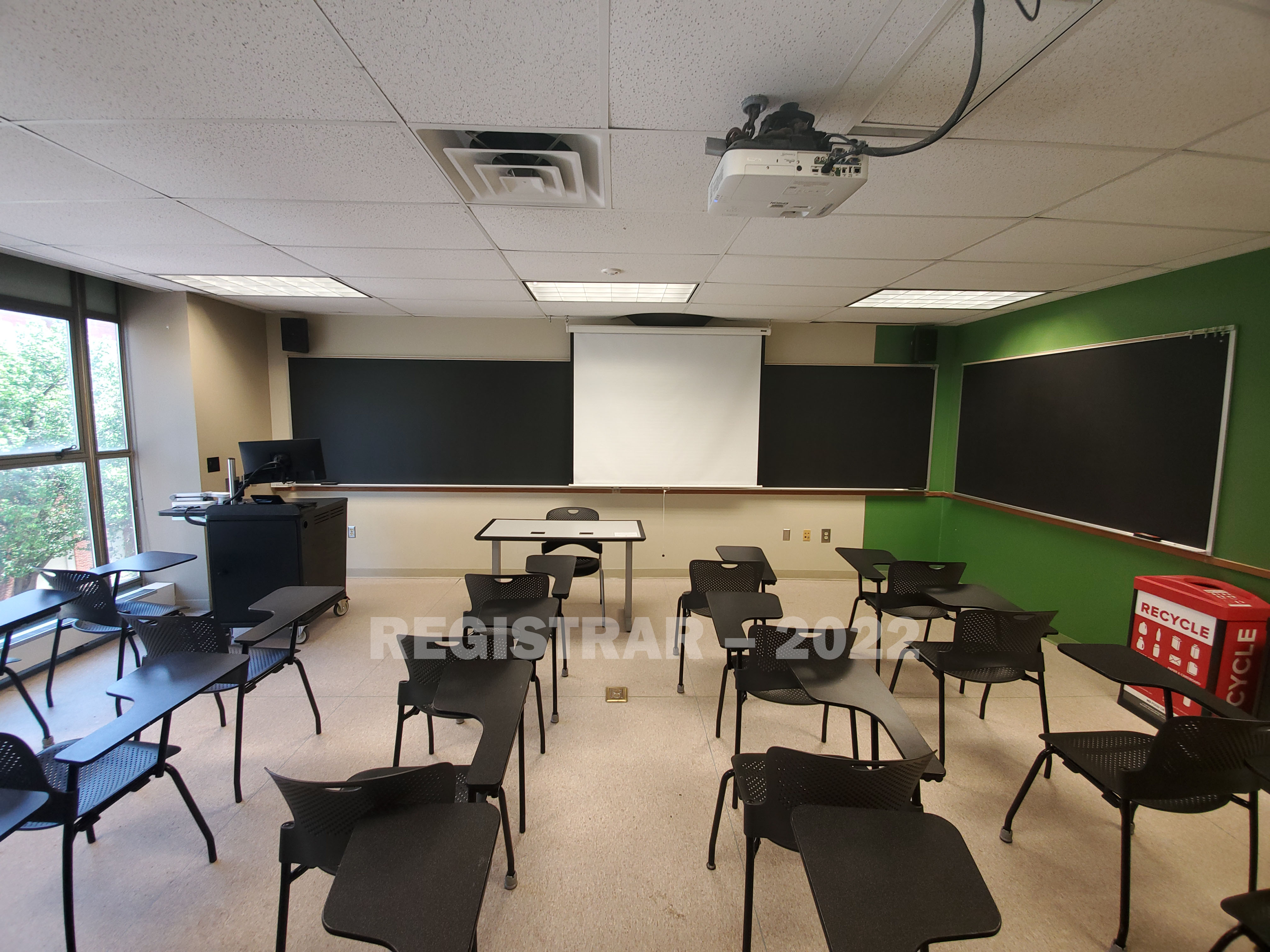 Enarson Classroom Building room 304 ultra wide angle view from the back of the room with projector screen down