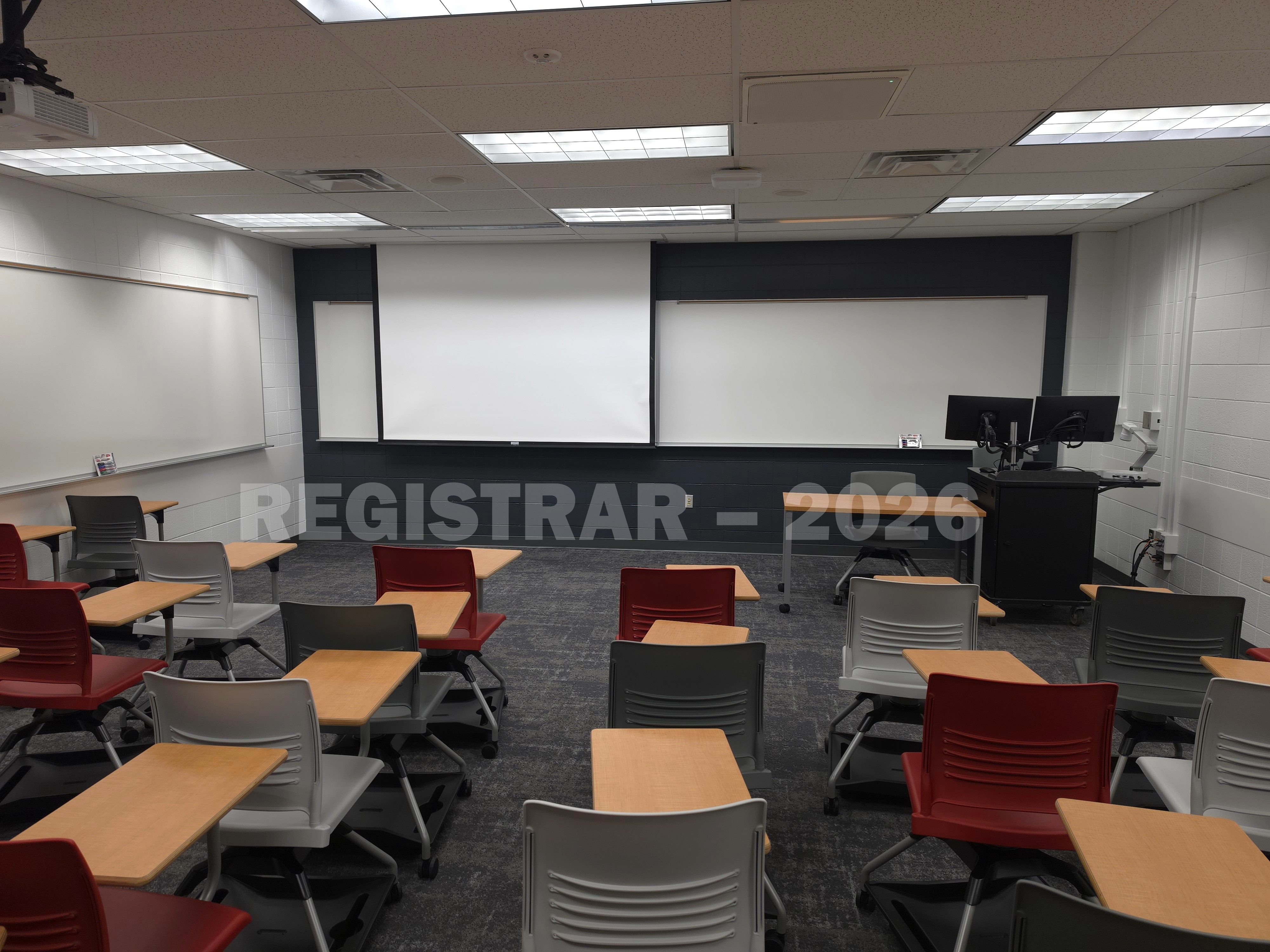 University Hall room 51 view from the back of the room with projector screen down