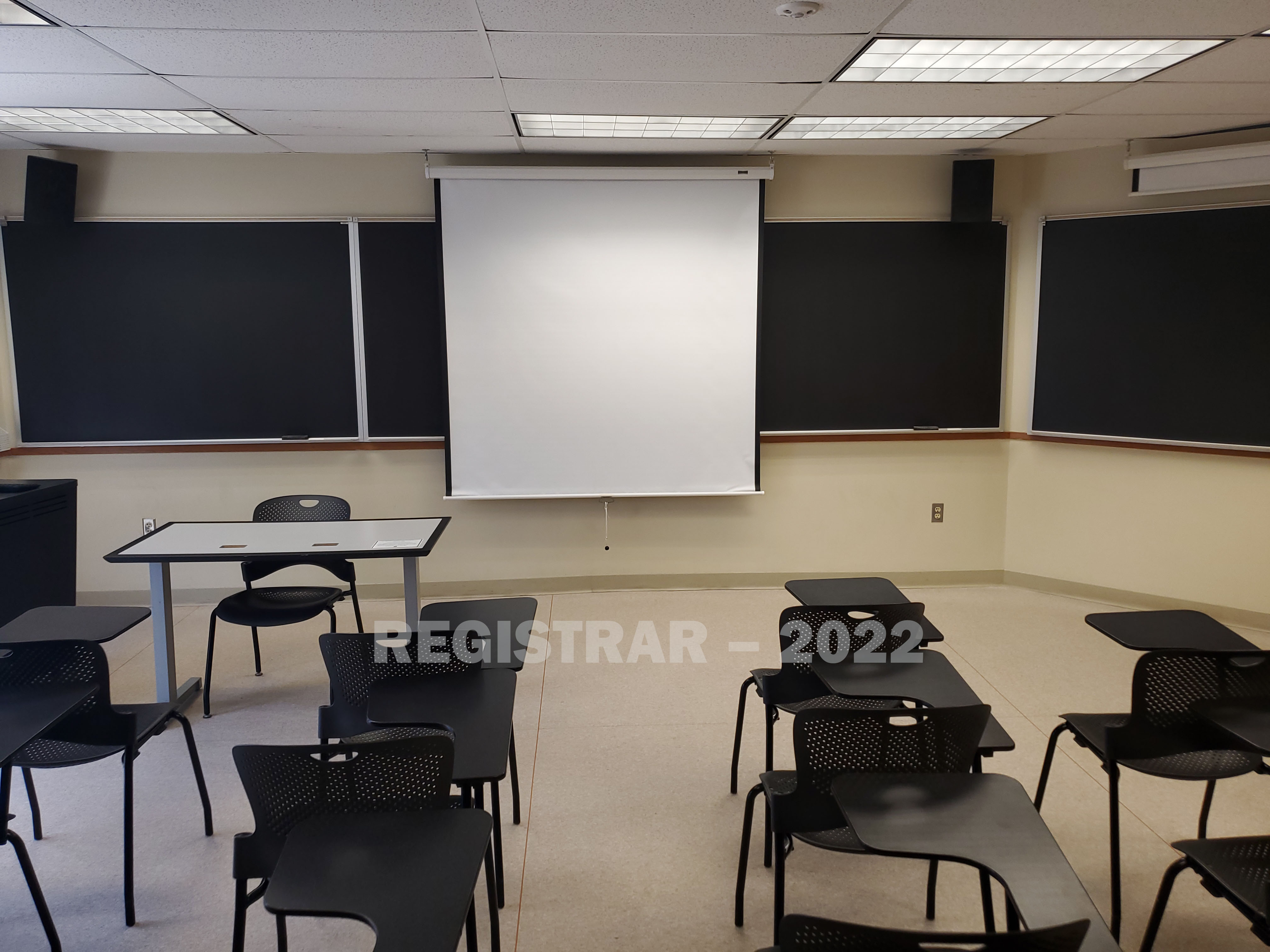 Enarson Classroom Building room 354 view from the back of the room with projector screen down